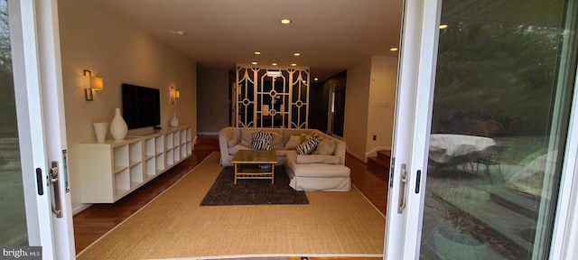 living area with wood finished floors and recessed lighting