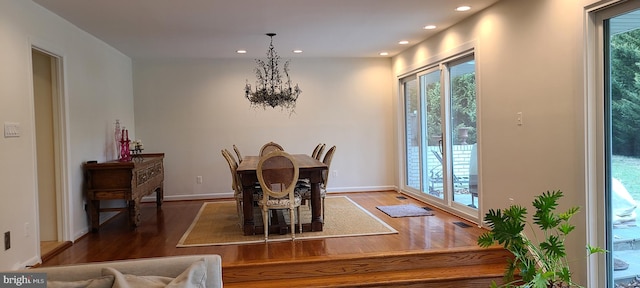 dining space with an inviting chandelier, visible vents, wood finished floors, and recessed lighting