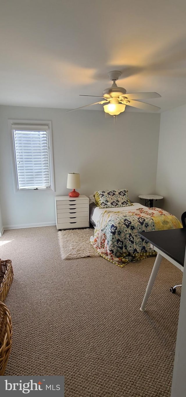 unfurnished bedroom featuring a ceiling fan, carpet flooring, and baseboards