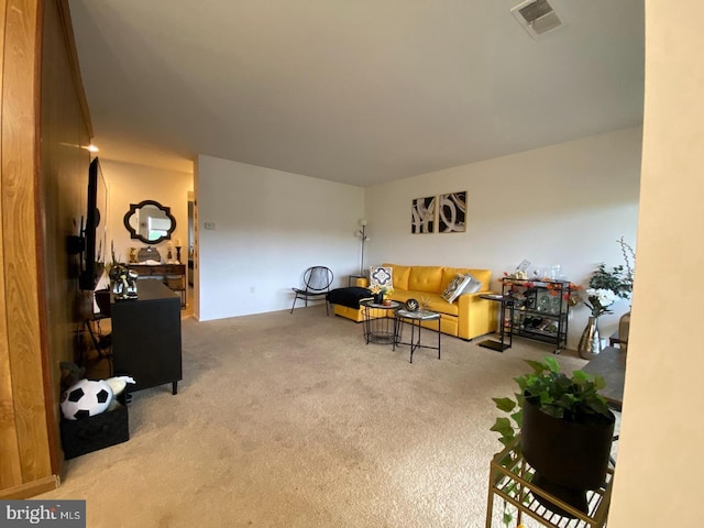 living area featuring carpet floors and visible vents