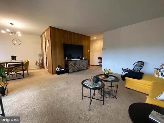 carpeted living room featuring an inviting chandelier