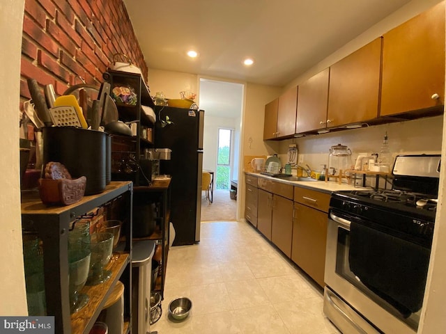 kitchen with stainless steel appliances, a sink, light countertops, and recessed lighting