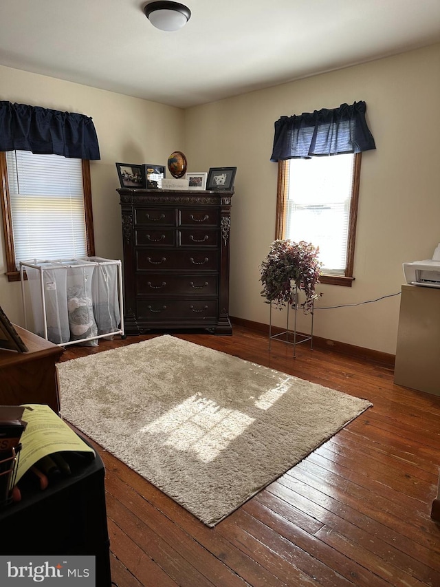 bedroom featuring hardwood / wood-style flooring and baseboards