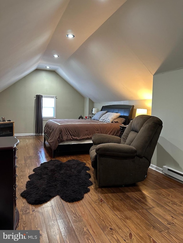 bedroom featuring lofted ceiling, a baseboard heating unit, hardwood / wood-style flooring, and baseboards