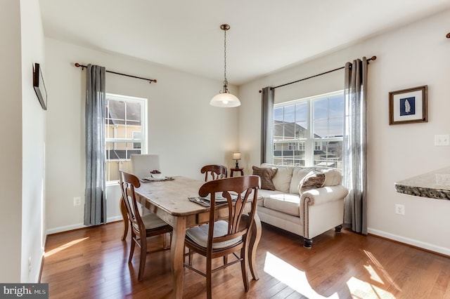 dining area with wood finished floors and baseboards