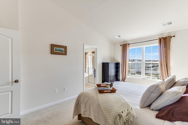 carpeted bedroom with vaulted ceiling, connected bathroom, visible vents, and baseboards