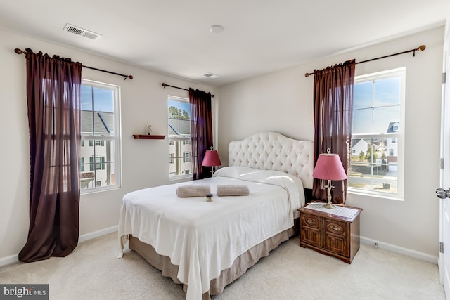 bedroom featuring light colored carpet, visible vents, and baseboards