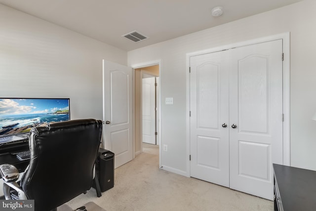 office with baseboards, visible vents, and light colored carpet