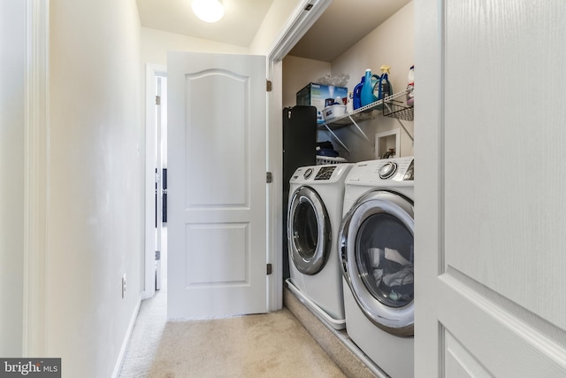 clothes washing area with carpet floors, laundry area, and washing machine and dryer