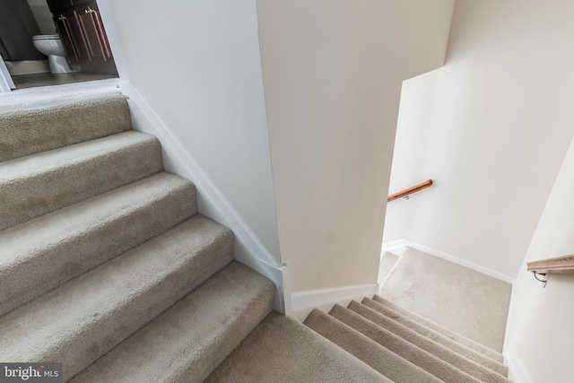 staircase with carpet flooring and baseboards