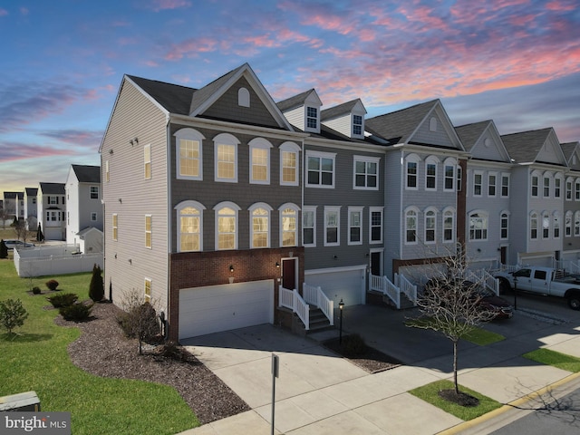 view of property featuring driveway, an attached garage, a residential view, and entry steps