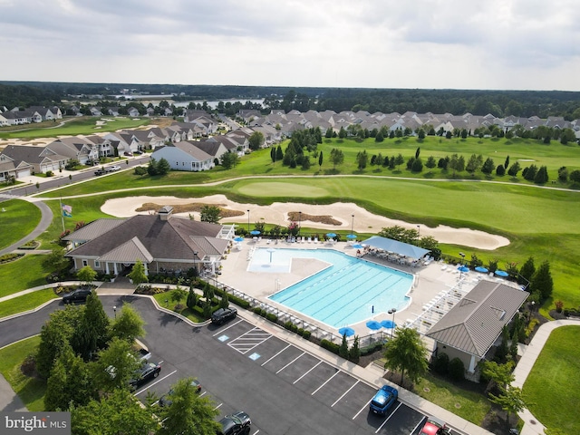 drone / aerial view with view of golf course and a residential view