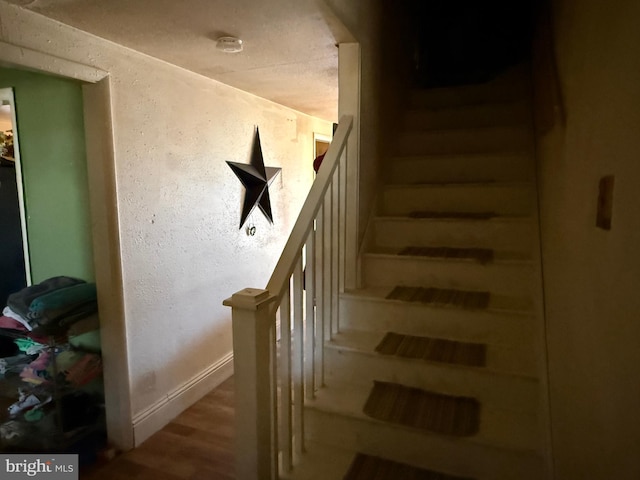 stairs with baseboards and wood finished floors