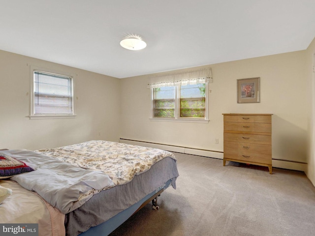 bedroom with light colored carpet and a baseboard heating unit