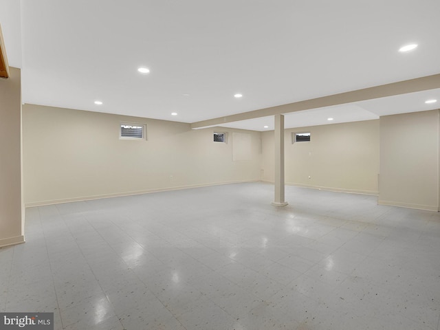 finished below grade area featuring recessed lighting, baseboards, and light floors