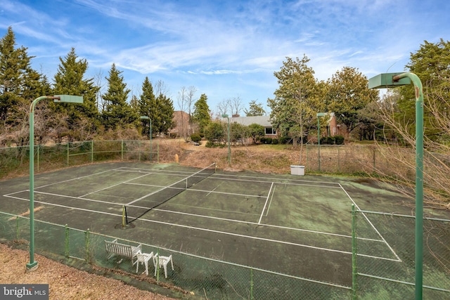 view of sport court featuring fence