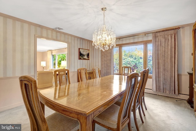 dining area with visible vents, light colored carpet, an inviting chandelier, and wallpapered walls