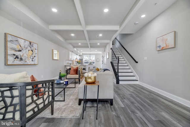 living room featuring baseboards, stairs, beam ceiling, wood finished floors, and coffered ceiling