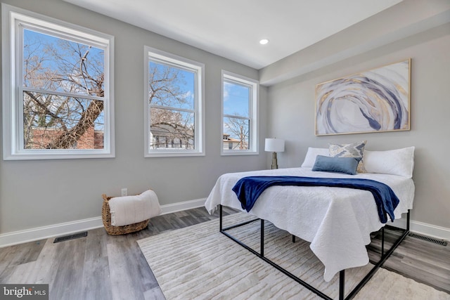 bedroom with visible vents, recessed lighting, wood finished floors, and baseboards