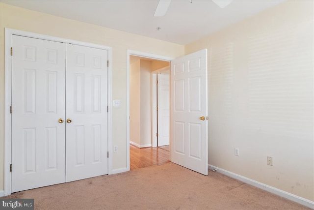 unfurnished bedroom featuring a closet, baseboards, and carpet flooring