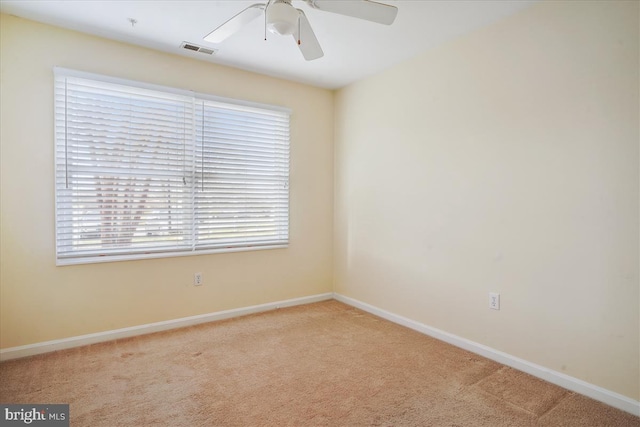 unfurnished room with carpet, visible vents, ceiling fan, and baseboards