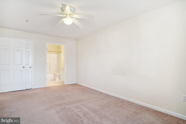 unfurnished bedroom featuring carpet flooring, connected bathroom, and baseboards