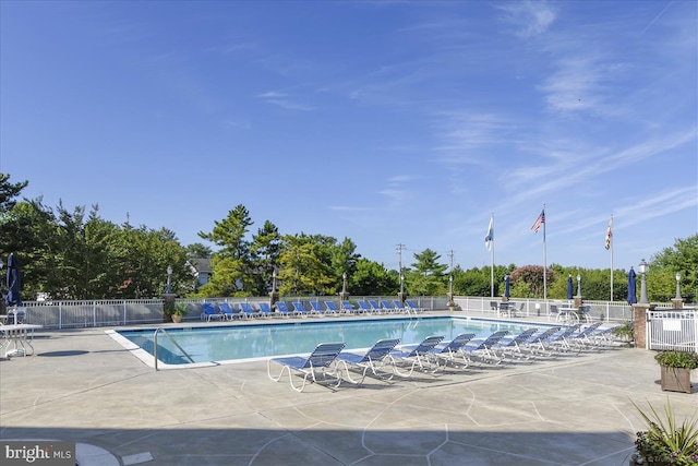 community pool featuring fence and a patio