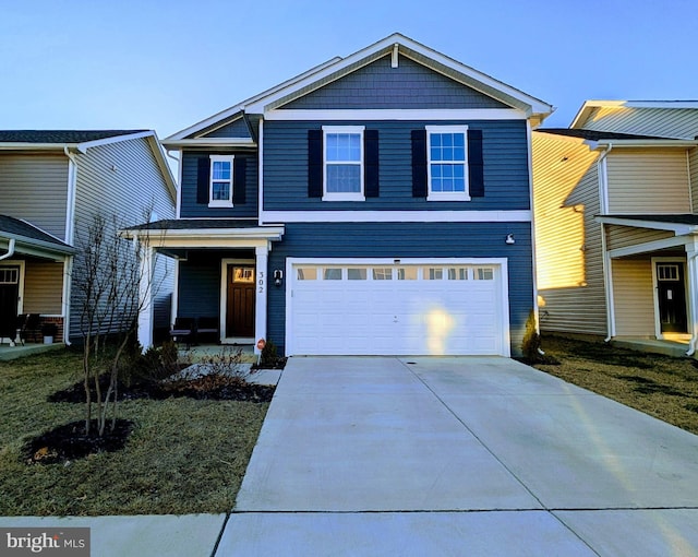 traditional home featuring concrete driveway and a garage