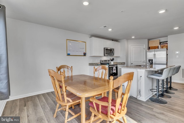 dining area with recessed lighting, visible vents, baseboards, and light wood-style floors