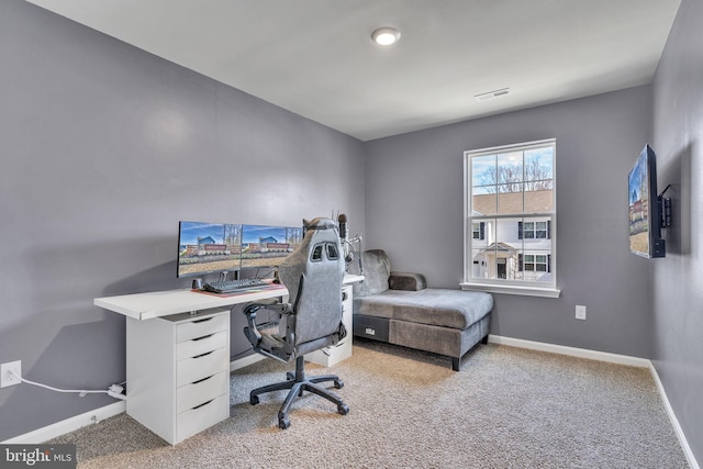 carpeted office space featuring baseboards and visible vents