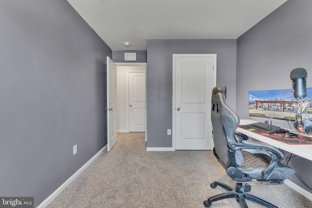 carpeted home office featuring visible vents and baseboards