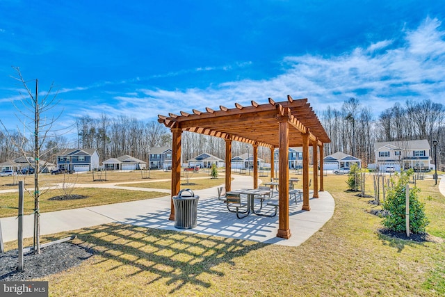 view of property's community featuring a patio area, a residential view, a pergola, and a yard