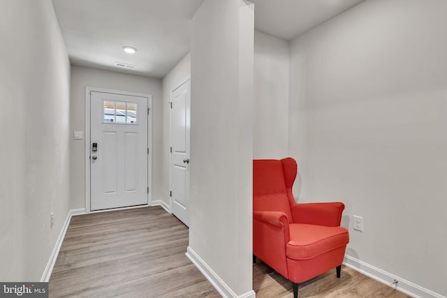 entryway with visible vents, baseboards, and wood finished floors