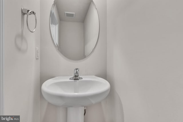 bathroom with visible vents and a sink