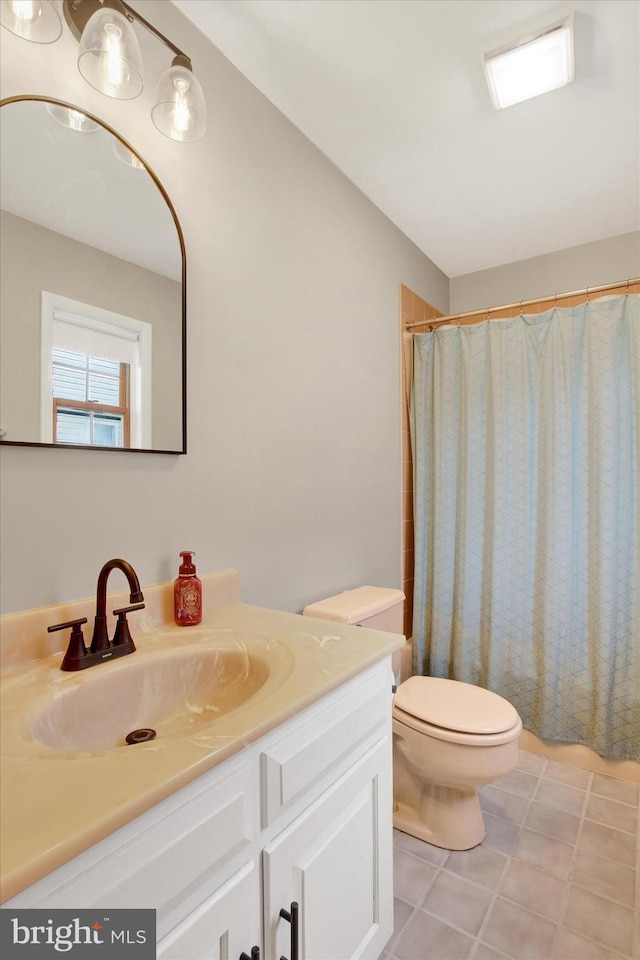 full bath with curtained shower, toilet, vanity, and tile patterned flooring