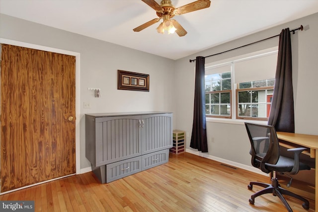 office area featuring visible vents, baseboards, a ceiling fan, and hardwood / wood-style flooring