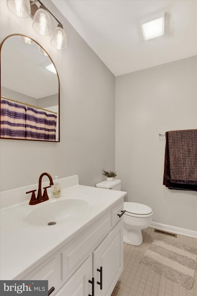 bathroom with visible vents, toilet, tile patterned flooring, baseboards, and vanity