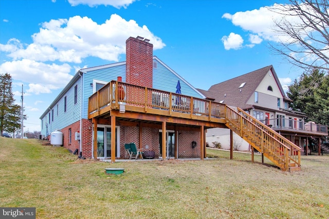 rear view of property with stairs, a wooden deck, a yard, and a chimney