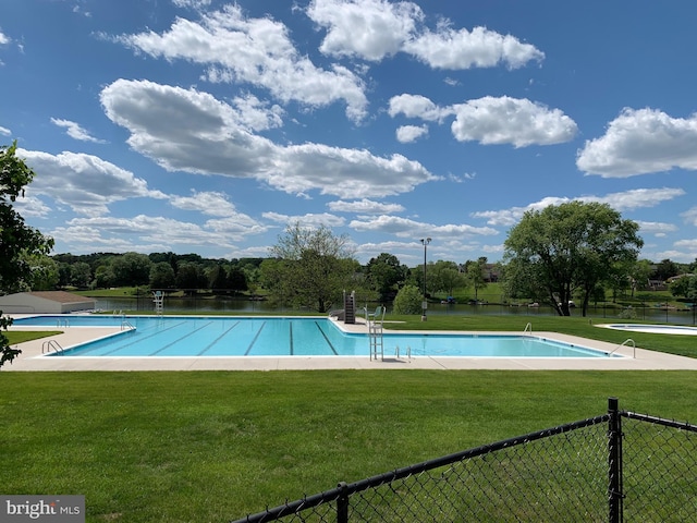 pool with a lawn and fence