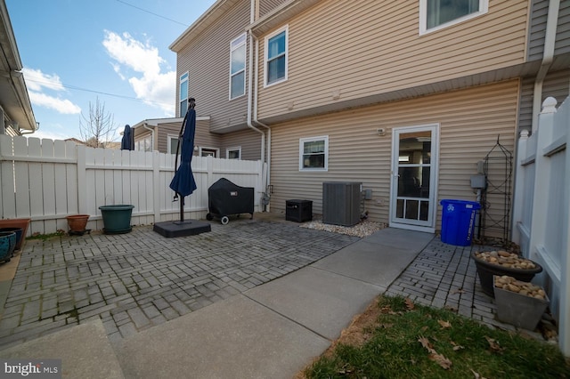 view of patio / terrace featuring cooling unit and fence