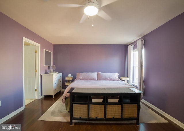 bedroom featuring ceiling fan, baseboards, and wood finished floors