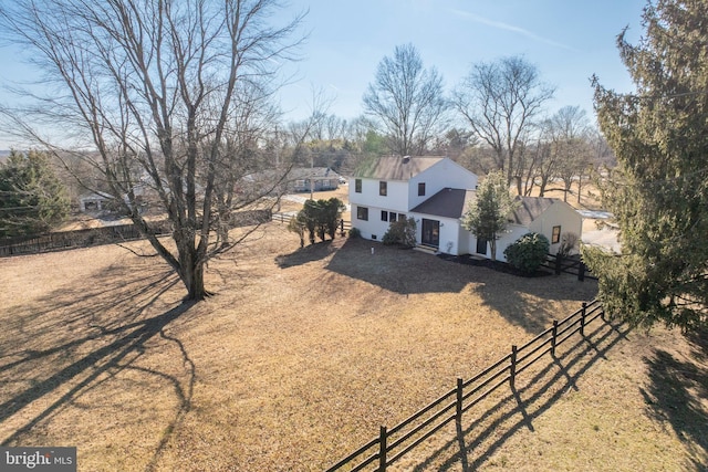 view of front facade with fence and driveway