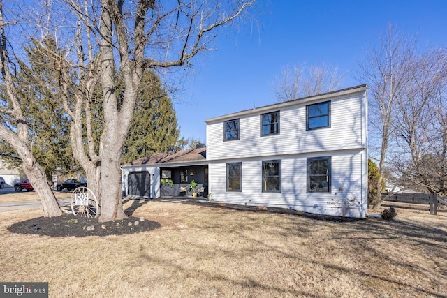 colonial house with a garage and a front lawn