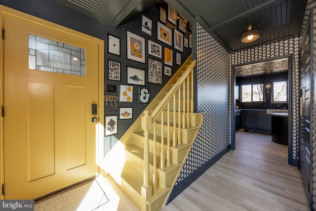 foyer entrance with stairs and wood finished floors