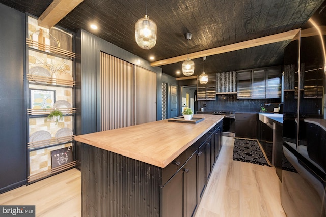 kitchen with light wood-style floors, wooden counters, beamed ceiling, and stainless steel electric stove