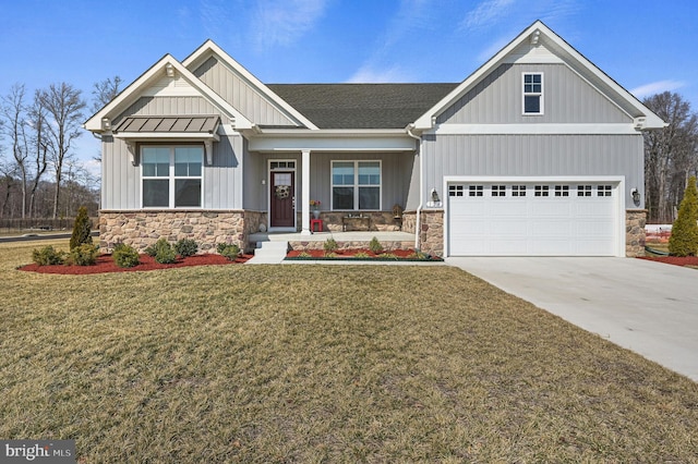 craftsman inspired home featuring a garage, concrete driveway, board and batten siding, a front lawn, and a standing seam roof