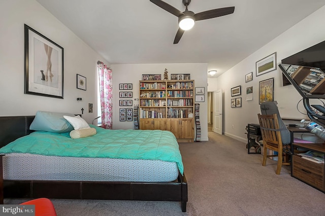 carpeted bedroom with a ceiling fan and baseboards