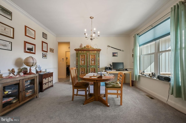 carpeted dining area featuring baseboards, ornamental molding, visible vents, and an inviting chandelier