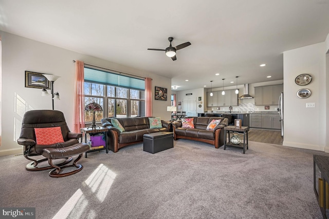 living room featuring recessed lighting, carpet flooring, a ceiling fan, and baseboards