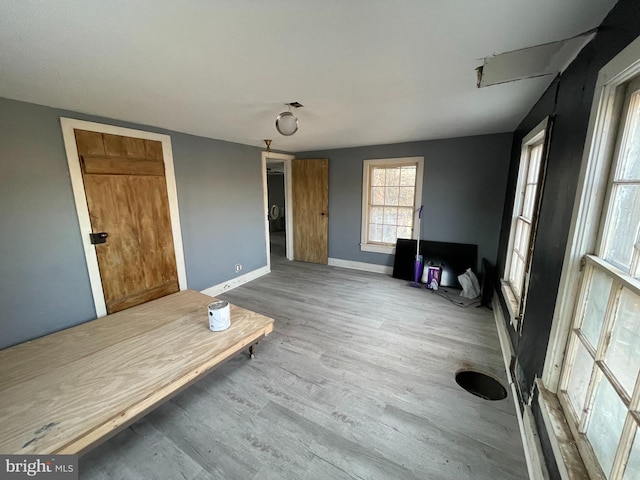 interior space with wood finished floors and baseboards